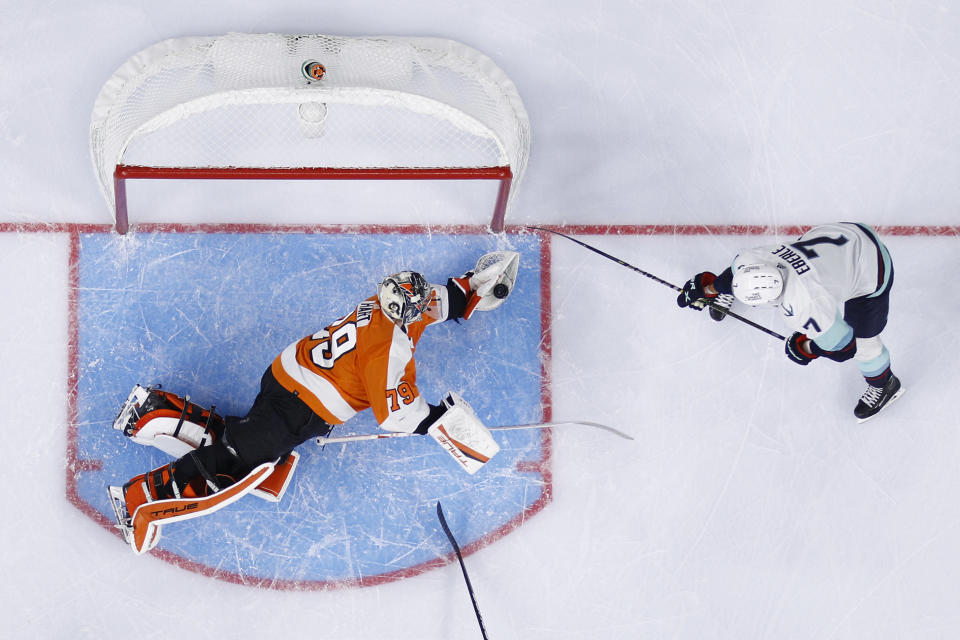 Philadelphia Flyers' Carter Hart, left, blocks a shot by Seattle Kraken's Jordan Eberle during the first period of an NHL hockey game, Monday, Oct. 18, 2021, in Philadelphia. (AP Photo/Matt Slocum)