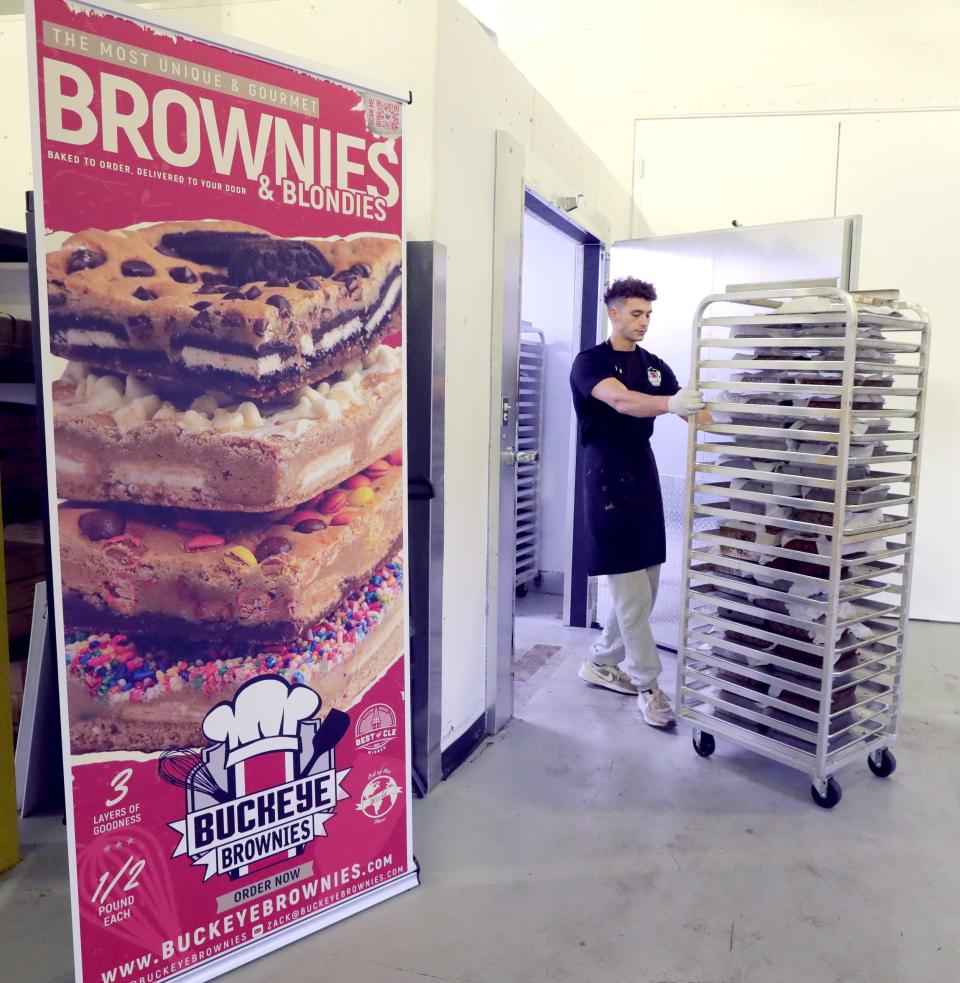 Buckeye Brownies worker Mitchel Markusic wheels a cart of Peanut Butter Pie brownies into a refrigerator Tuesday.