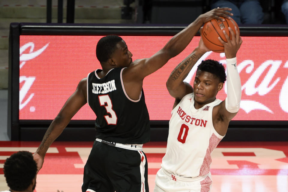 Houston guard Marcus Sasser (0) looks to pass as Lamar guard Ellis Jefferson (3) defends during the second half of an NCAA college basketball game, Wednesday, Nov. 25, 2020, in Houston. (AP Photo/Eric Christian Smith)