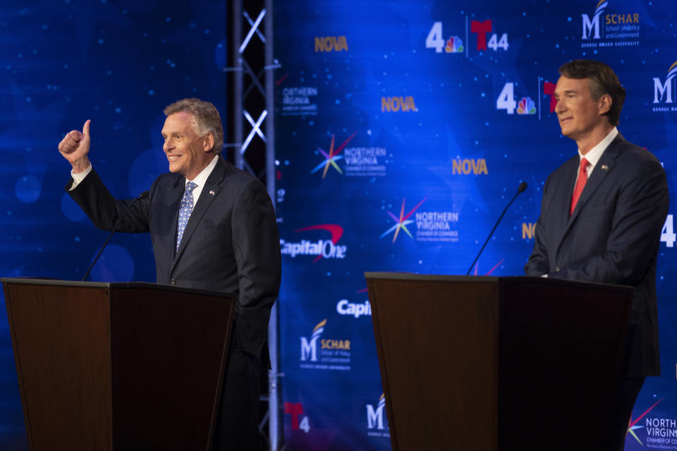 Virginia Democratic gubernatorial candidate and former Gov. Terry McAuliffe, left, and Republican challenger, Glenn Youngkin, participate in a debate at Northern Virginia Community College, in Alexandria, Va., Tuesday, Sept. 28, 2021. (AP Photo/Cliff Owen)