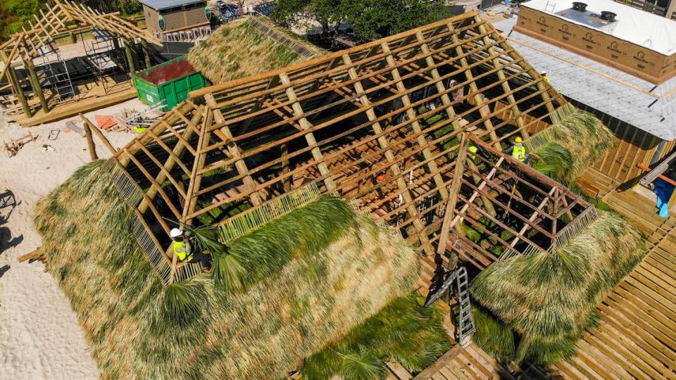 Workers with Big Cypress Tiki Huts based out of Florida work on Wednesday, April 24, 2024 to build a roof for The Beach House Hilton Head Island’s new tiki hut at Coligny Beach on Hilton Head. It will take about four days to complete the roof for the bar and the new musical acts stage, top left.