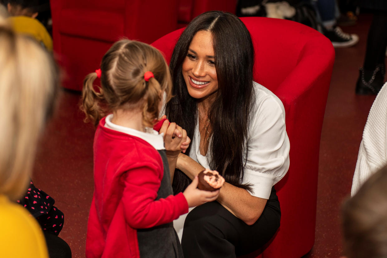 Poppy Dean gives a cake to Britain’s Meghan, Duchess of Sussex during a coffee morning with families of deployed Army personnel at Broom Farm Community Centre in Windsor, Britain November 6, 2019. Picture taken November 6, 2019. Sgt Paul Randall/MoD/Handout via REUTERS  THIS IMAGE HAS BEEN SUPPLIED BY A THIRD PARTY.