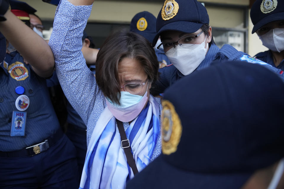 Detained former opposition Sen. Leila de Lima walks under tight security after she went to a court hearing which was later postponed in Muntinlupa, Philippines, Monday, Oct. 10, 2022. Human rights activists pressed their call Monday for the immediate release of de Lima after she was taken hostage in a rampage by three Muslim militants in a failed attempt to escape from a maximum-security jail. (AP Photo/Aaron Favila)