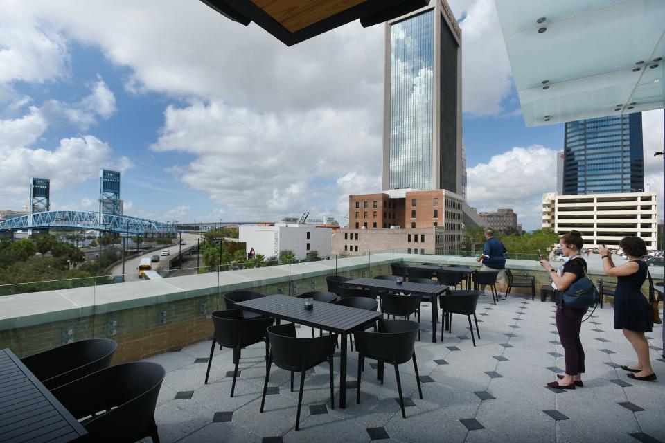 The rooftop lounge at Cowford Chophouse offers views of the Main Street bridge and the downtown riverfront.