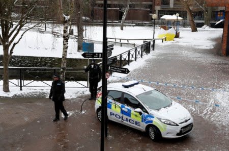 Police officers stand at the cordon near the tent covering the park bench where former Russian intelligence officer Sergei Skripal and his daughter Yulia were found poisoned in Salisbury, Britain, March 19, 2018. REUTERS/Peter Nicholls