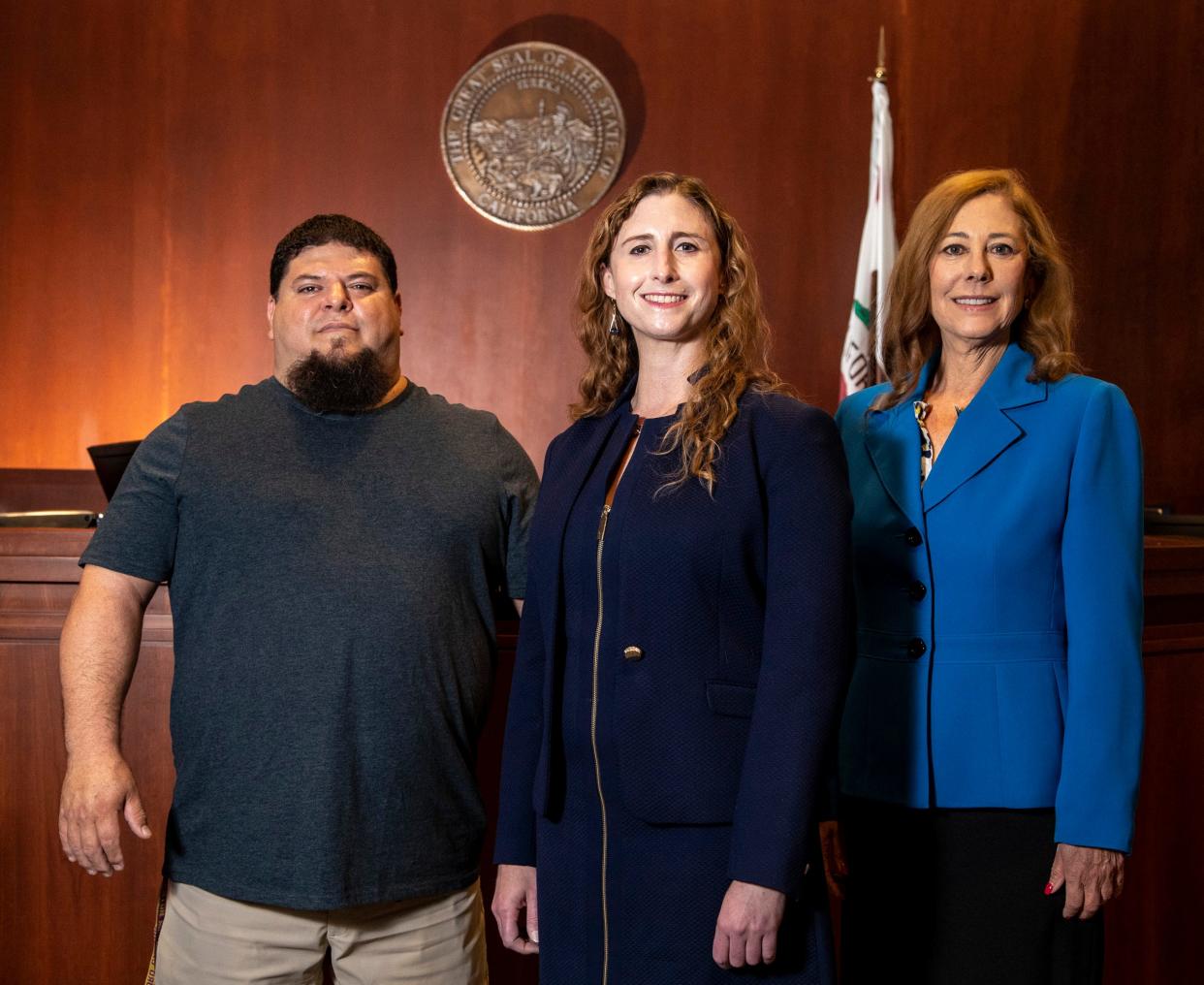 Teacher Eddie Mendez (left), Riverside County Superior Court Judge Kira Klatchko (center) and Deputy District Attorney Rosalind Miller (right) pose for a photo together at the Palm Springs courthouse in Palm Springs, Calif., Tuesday, Aug. 2, 2022. 