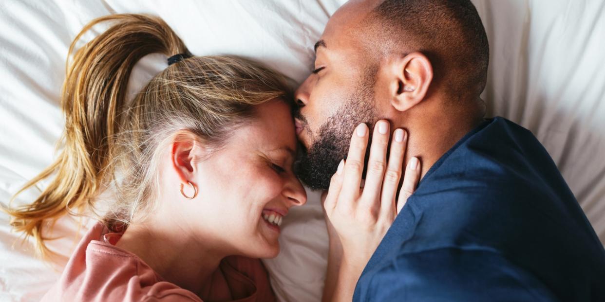 couple cuddling together in bed infertility