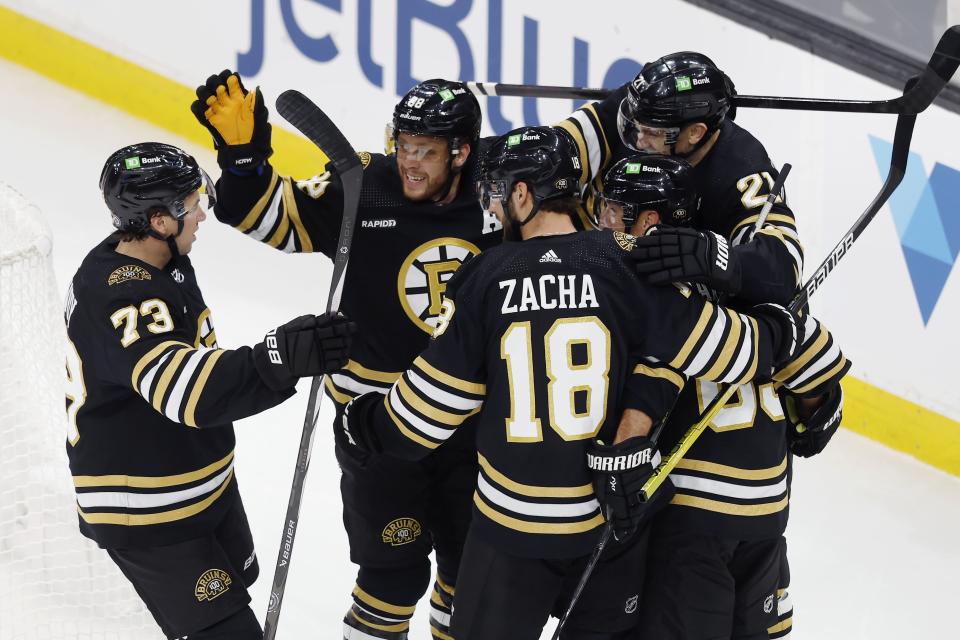 Boston Bruins' James van Riemsdyk (21) celebrates his goal with Pavel Zacha (18), Charlie McAvoy (73), David Pastrnak (88) and Brad Marchand (63) during the first period of an NHL hockey game against the Nashville Predators, Saturday, Oct. 14, 2023, in Boston. (AP Photo/Michael Dwyer)