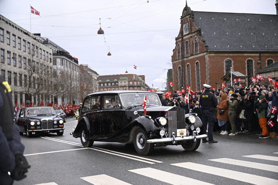 Denmark's Crown Prince Frederik and Crown Princess Mary look on, during the drive from Amalienborg Castle to Christiansborg Castle in Copenhagen, Sunday, Jan. 14, 2024. Denmark's Crown Prince Frederik takes over the crown on Sunday from his mother, Queen Margrethe II, who is breaking with centuries of Danish royal tradition and retiring after a 52-year reign. (Nils Meilvang/Ritzau Scanpix via AP)