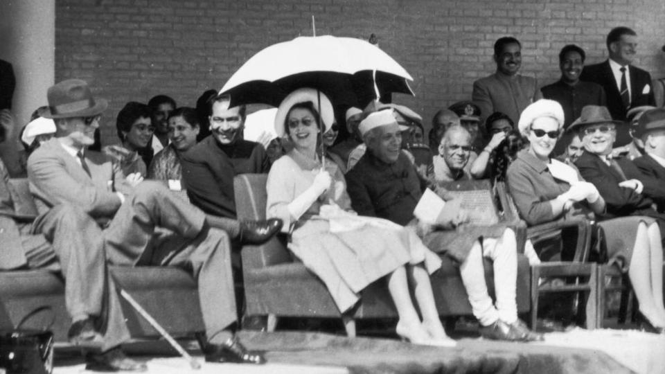 Queen Elizabeth II shares a joke with husband Prince Philip, Duke of Edinburgh and Indian Prime Minister Pandit Nehru (1889 - 1964) during a National Cadet Corps rally in New Delhi