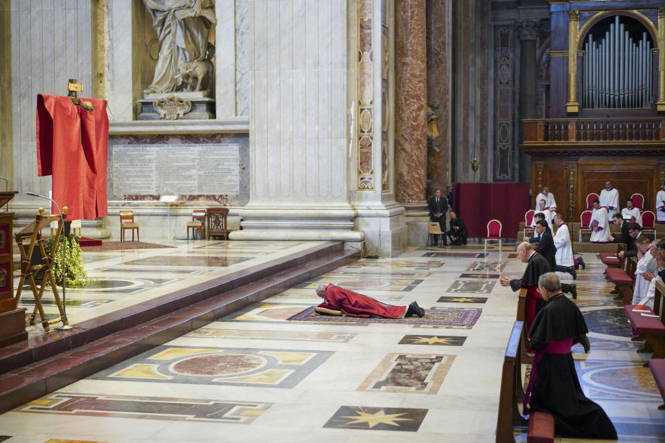 Pope Francis lies down in prayer prior to celebrate Mass for the Passion of Christ, at St. Peter's Basilica, at the Vatican, Friday, April 10, 2020. The new coronavirus causes mild or moderate symptoms for most people, but for some, especially older adults and people with existing health problems, it can cause more severe illness or death. (AP Photo/Andrew Medichini, Pool)