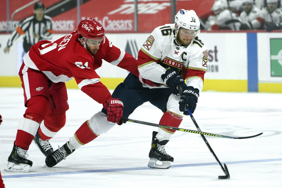 Detroit Red Wings center Frans Nielsen (81) defends Florida Panthers center Aleksander Barkov (16) in the first period of an NHL hockey game Sunday, Jan. 31, 2021, in Detroit. (AP Photo/Paul Sancya)