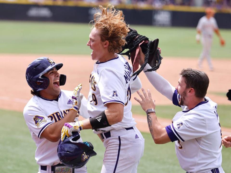 East Carolina’s Alec Makarewicz (99) celebrates with Zach Agnos (14) and Ryder Giles (3), right, after hitting a homerun during ECUs 13-7 victory over Texas in the Greenville Super Regional at Clark-LeClair Stadium Friday, June 10, 2022.