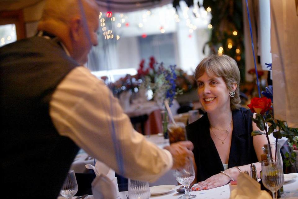 In this file photo from Oct. 11, 2004, a waiter at a Coral Gables restaurant serves a customer meals that she can eat that don’t affect her allergies.