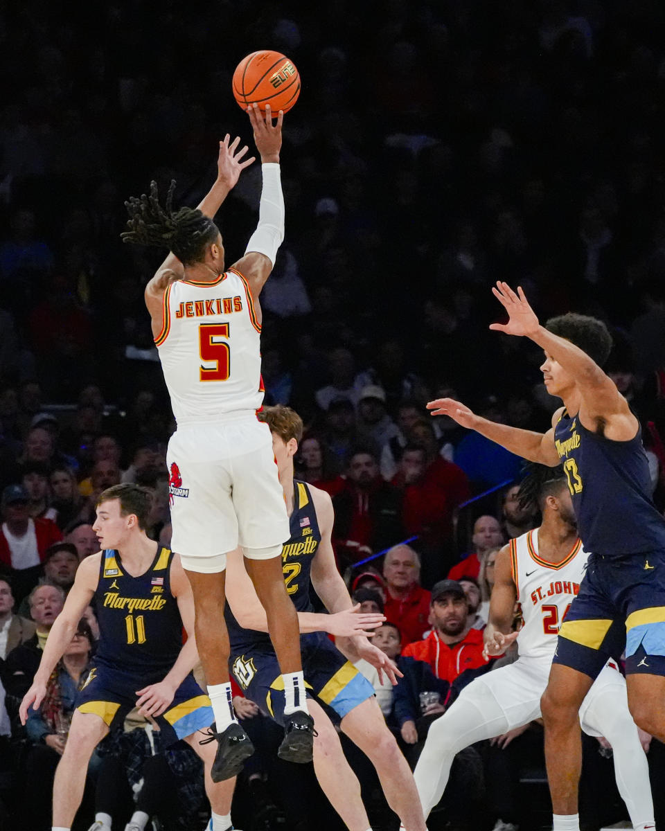 St. John's guard Daniss Jenkins (5) shoots over Marquette forward Oso Ighodaro (13) during the first half of an NCAA college basketball game in New York, Saturday, Jan. 20, 2024. (AP Photo/Peter K. Afriyie)