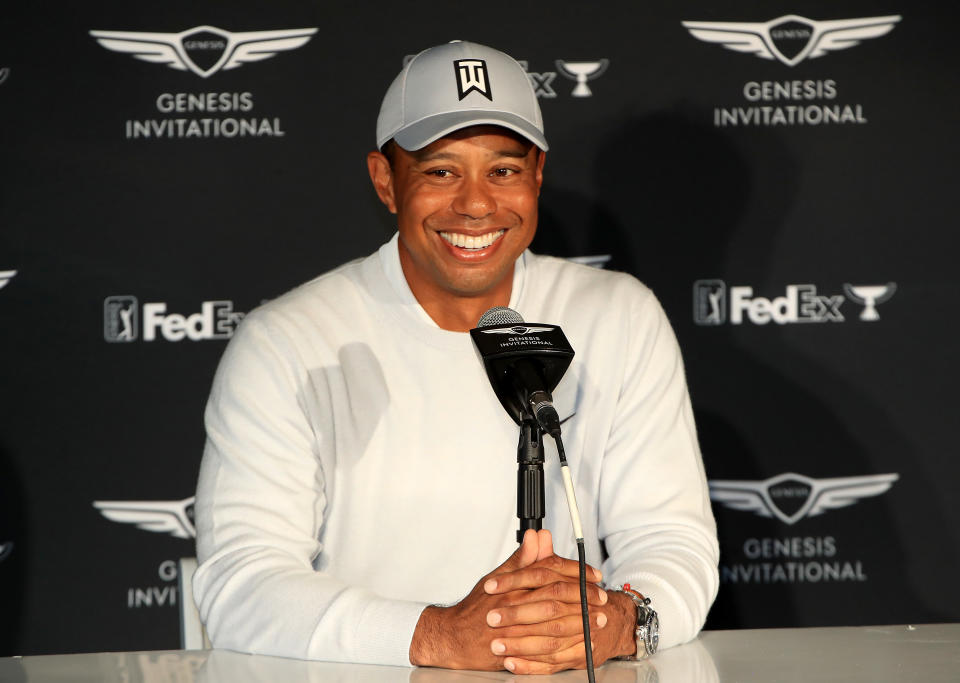 Tiger Woods smiles during a press conference.