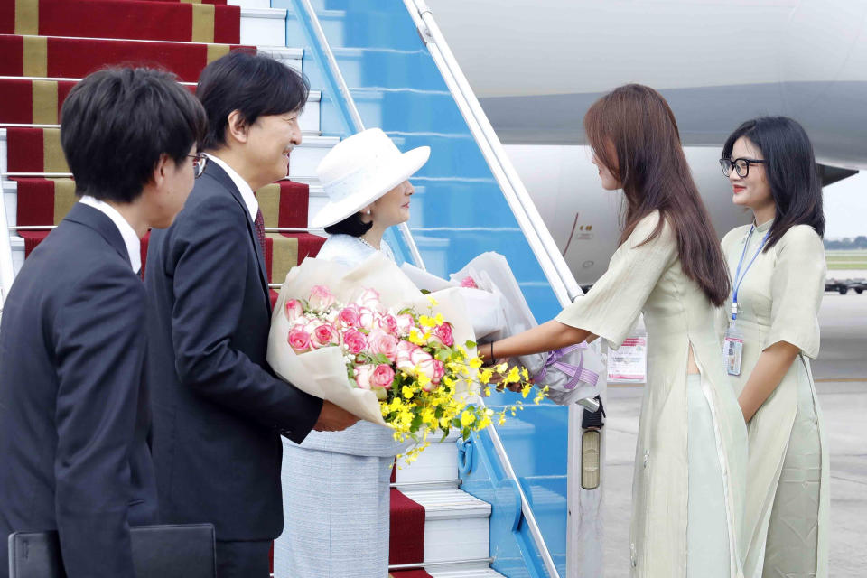 Japanese Crown Prince Akishino, second left, and Crown Princess Kiko, third left, receive flowers from Vietnamese officials after landing in Hanoi, Vietnam Wednesday, Sept. 20, 2023. They are on a visit to Vietnam to mark the 50th anniversary of the diplomatic relation between the two countries. (An Van Dang/VNA via AP)