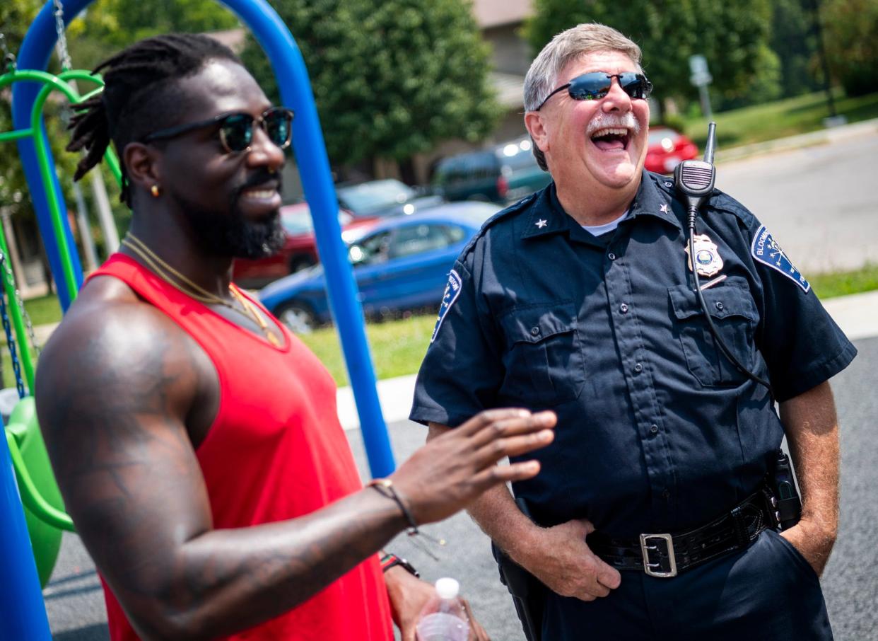 Dean Armbrister, left, and Bloomington Police Department Chief Mike Diekhoff share a laugh with Shatoyia Moss, off camera, Aug. 7, 2021, at the Crestmont Community Cookout at the Crestmont Community Circle.