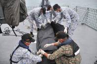 <p>In this photo released by the Royal Malaysian Navy, navy sailors cover an unidentified body on to the deck of KD Lekiu frigate after it was recovered in the waters off the Johor coast of Malaysia, Aug. 22, 2017. (Photo: Royal Malaysian Navy via AP) </p>