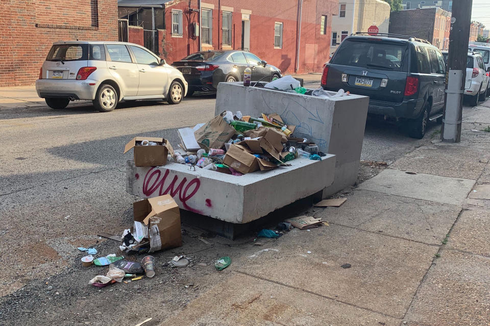 Trash rests piled up on a street Monday, July 27, 2020, in Philadelphia. The COVID-19 pandemic has frustrated efforts to keep Philadelphia's streets clear of garbage this summer. People are staying home and generating more garbage, but the sanitation department has been shorthanded and workers have fallen behind picking up household trash and recyclables. Residents complain about the stink and the flies. (Kara Kneidl via AP)