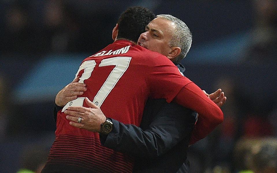 Jose Mourinho hugs Marouane Fellaini after his late winner against Young Boys in the Champions League - AFP