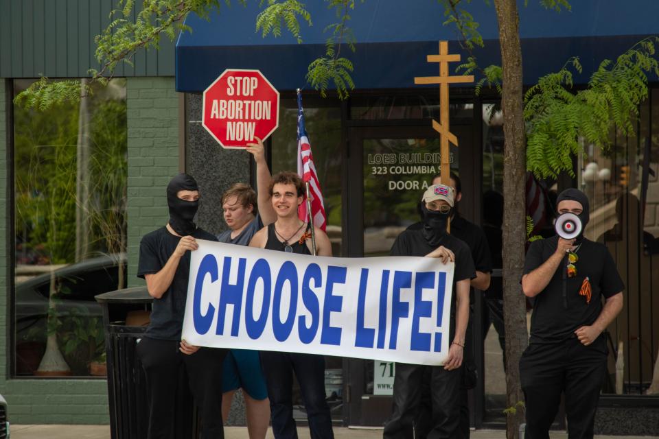 Across the street of the Tippecanoe County Courthouse, a counter-protester holds a sign to demonstrate against the "Bans Off Our Bodies" protest, on May 14, 2022, in Lafayette. "CHOOSE LIFE!" reads the sign.