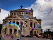 <p>A bubble artist performs with soap bubbles in front of the Old Opera in Frankfurt, Germany. (AP Photo/Michael Probst) </p>
