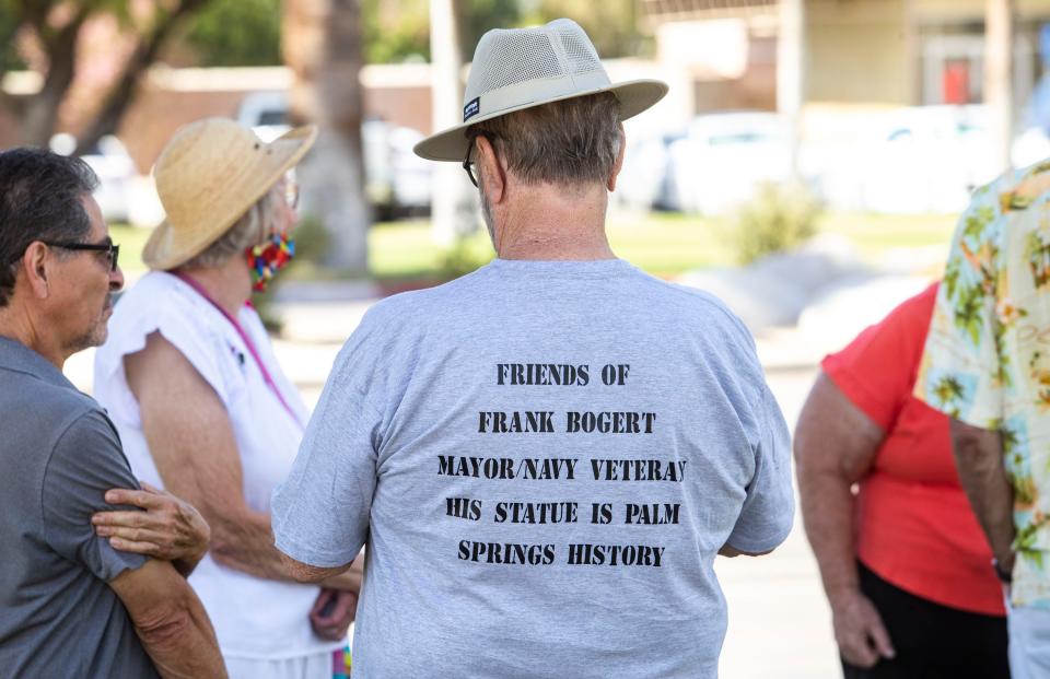 Gary Gillespie of Palm Springs wears a Friends of Frank Bogert t-shirt while standing near the Bogert statue to show his support of its preservation in Palm Springs, Calif., Friday, June 3, 2022. 