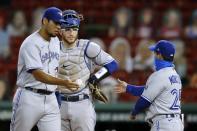 Toronto Blue Jays' Wilmer Font, left, hands the ball to manager Charlie Montoyo (25) as Danny Jansen looks on during a pitching change in the fourth inning of a baseball game against the Boston Red Sox, Saturday, Aug. 8, 2020, in Boston. (AP Photo/Michael Dwyer)