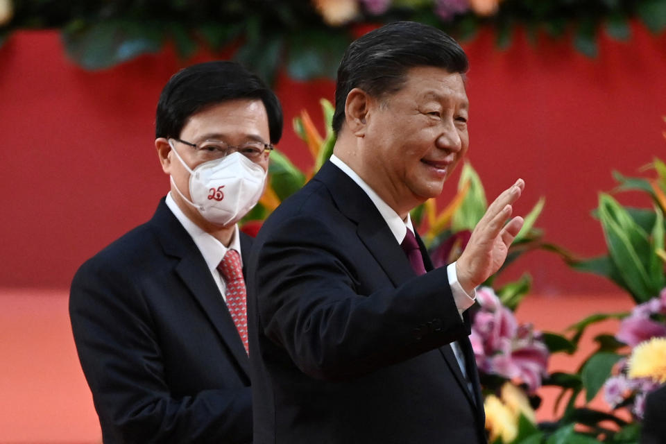 Hong Kong's new Chief Executive John Lee walks with China's President Xi Jinping following Xi's speech after a ceremony to inaugurate the city's new leader and government in Hong Kong, China, July 1, 2022, on the 25th anniversary of the city's handover from Britain to China.  Selim Chtayti/Pool via REUTERS