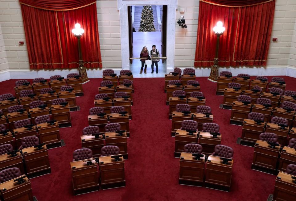 Maz Farzad and her URI grad student husband, Tom, take a peek inside the House chambers while visiting the State House for the first time on Tuesday afternoon.