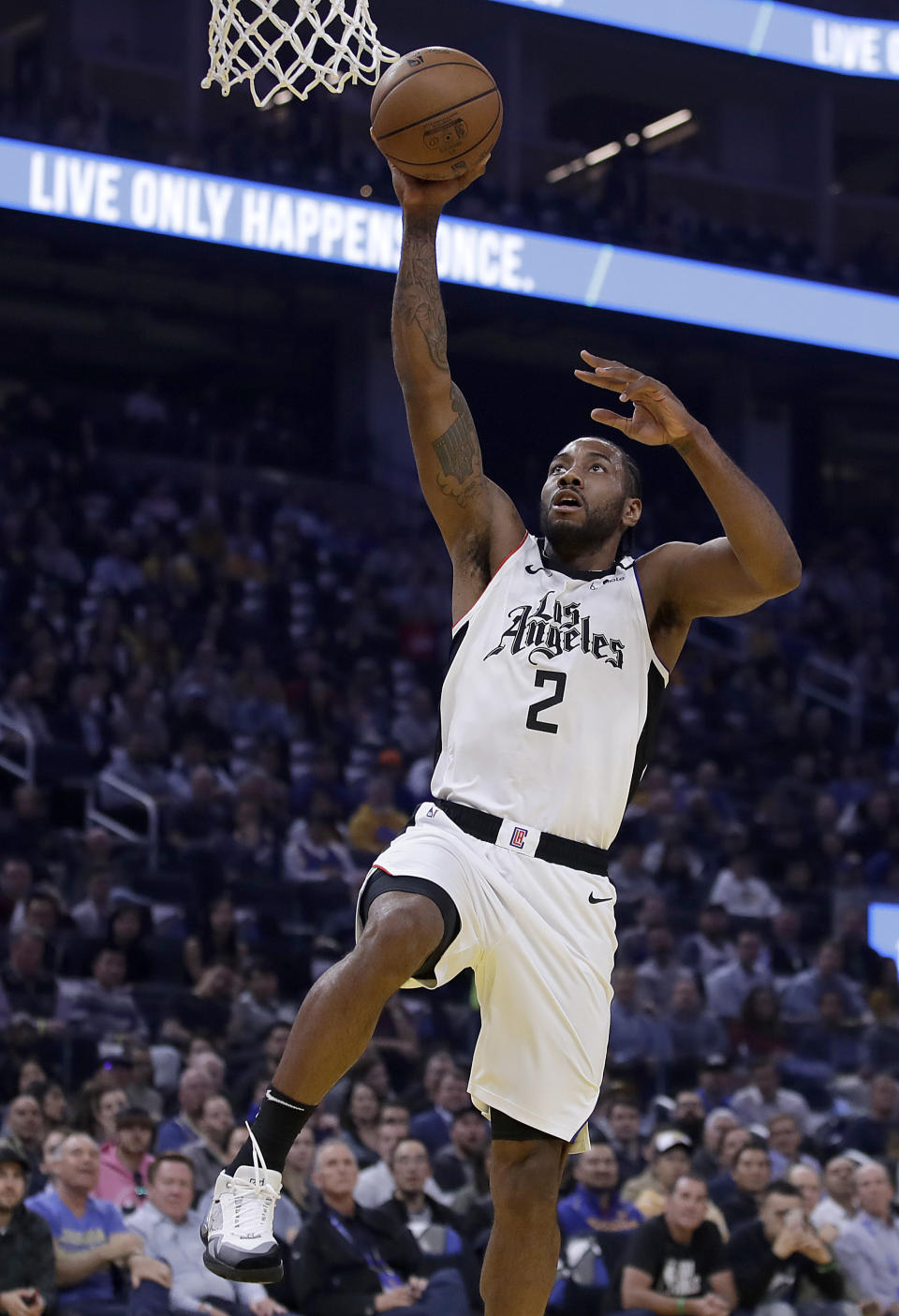 Los Angeles Clippers' Kawhi Leonard lays up a shot against the Golden State Warriors in the first half of an NBA basketball game Tuesday, March 9, 2020, in San Francisco. (AP Photo/Ben Margot)