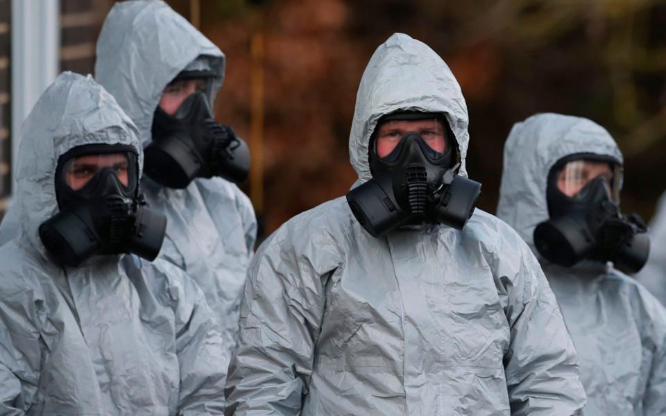 Security personnel in protective equipment at Sailsbury Hospital after the former Russian spy Sergei Skripal and his daughter were poisoned by a nerve agent - AFP