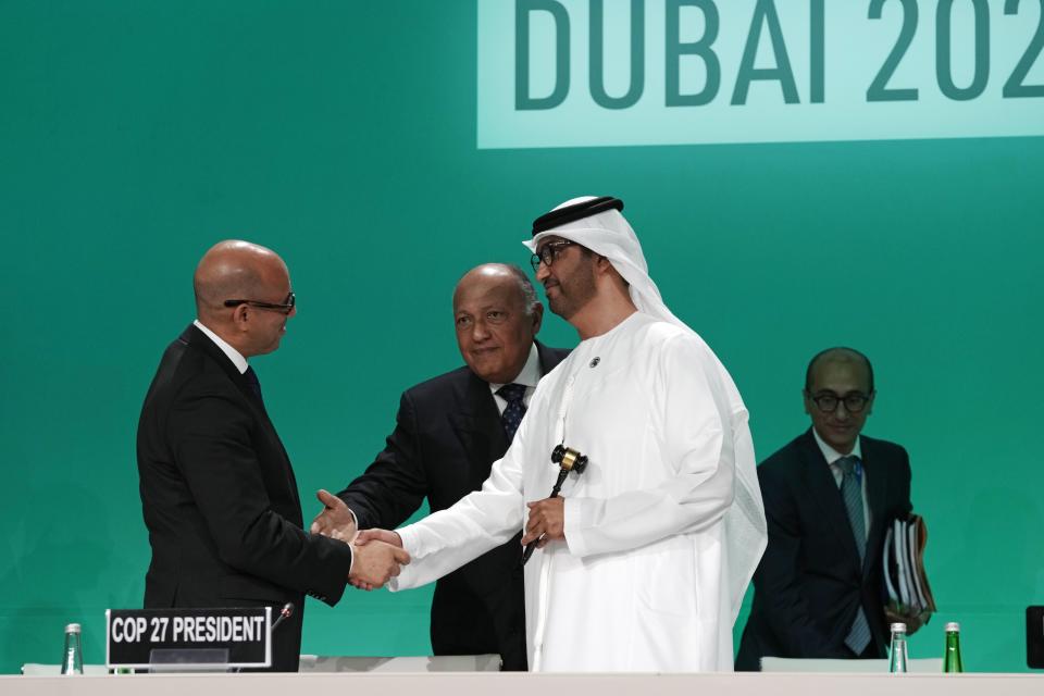 United Nations Climate Chief Simon Stiell, left, Sameh Shoukry, COP27 president, center, and COP28 President Sultan al-Jaber shake hands as they attend the opening session at the COP28 U.N. Climate Summit, Thursday, Nov. 30, 2023, in Dubai, United Arab Emirates. (AP Photo/Peter Dejong)