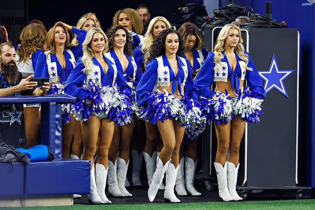 <p>Wesley Hitt/Getty</p> Dallas Cowboy Cheerleaders perform during a game against the Indianapolis Colts at AT&T Stadium on December 4, 2022.