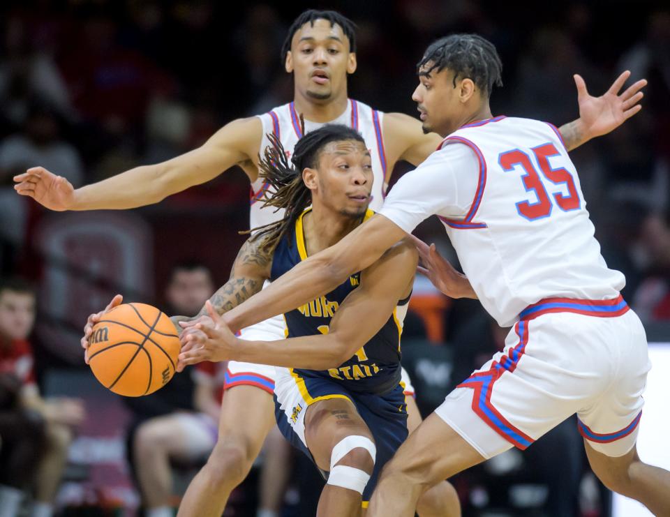 Bradly's Darius Hannah, right, and Zek Montgomery, background, team up on Murray State's Brian Moore Jr. in the first half Saturday, Feb. 11, 2023 at Carver Arena. The Braves rolled over the Racers 83-48.