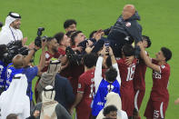 Qatar players lift Qatar's head coach Bartolome Marquez at full time of the Asian Cup final soccer match between Qatar and Jordan at the Lusail Stadium in Lusail, Qatar, Saturday, Feb. 10, 2024. Qatar won 3-1. (AP Photo/Hussein Sayed)