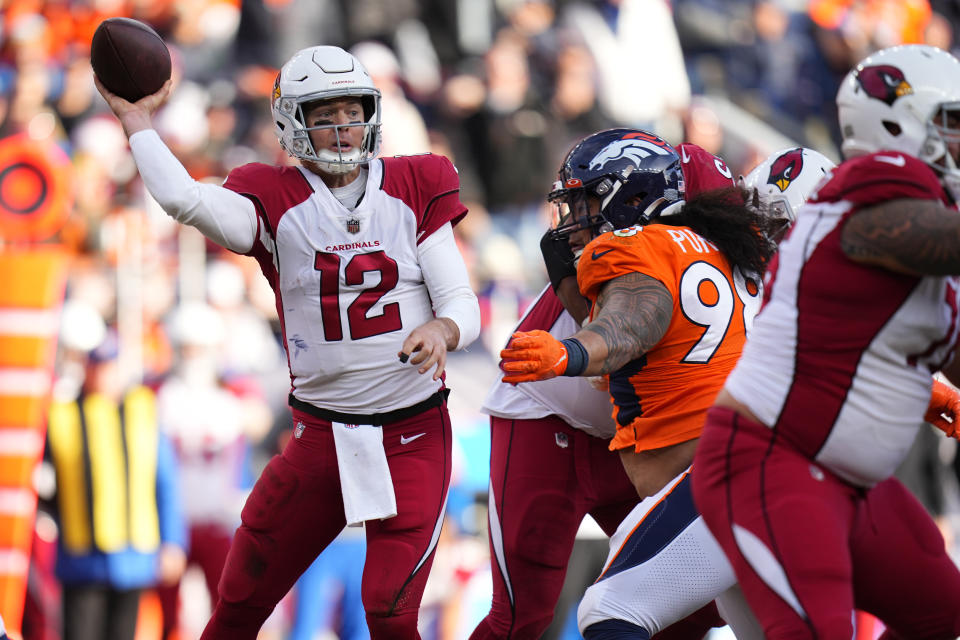 Arizona Cardinals quarterback Colt McCoy (12) throws under pressure from the Denver Broncos during the first half of an NFL football game, Sunday, Dec. 18, 2022, in Denver. (AP Photo/Jack Dempsey)