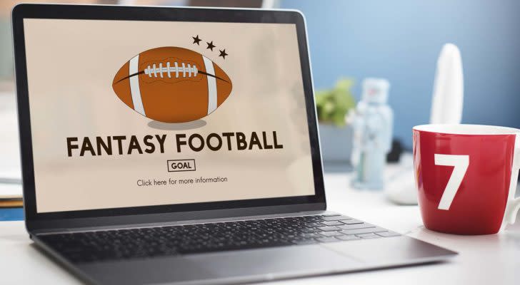 A laptop screen shows an illustration of a football and the phrase "Fantasy Football."