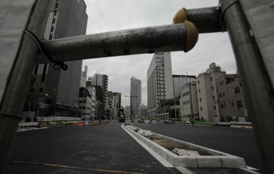 In this Thursday, Feb. 13, 2014 photo, a new by-pass road is under construction in Tokyo. Despite Japan’s prime minister Shinzo Abe's declaration that “Japan is back” in a speech last year to the New York Stock Exchange, Abe faces a thornier challenge in ensuring that his “Abenomics” recovery from two decades of economic stagnation spreads beyond boardrooms and investment portfolios. (AP Photo/Junji Kurokawa)