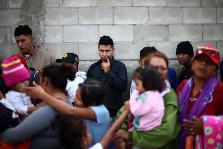 Members of a migrant caravan from Central America line up to receive breakfast at the end of their journey through Mexico, prior to preparations for an asylum request in the U.S., at a shelter in Tijuana, Baja California state, Mexico April 27, 2018. REUTERS/Edgard Garrido