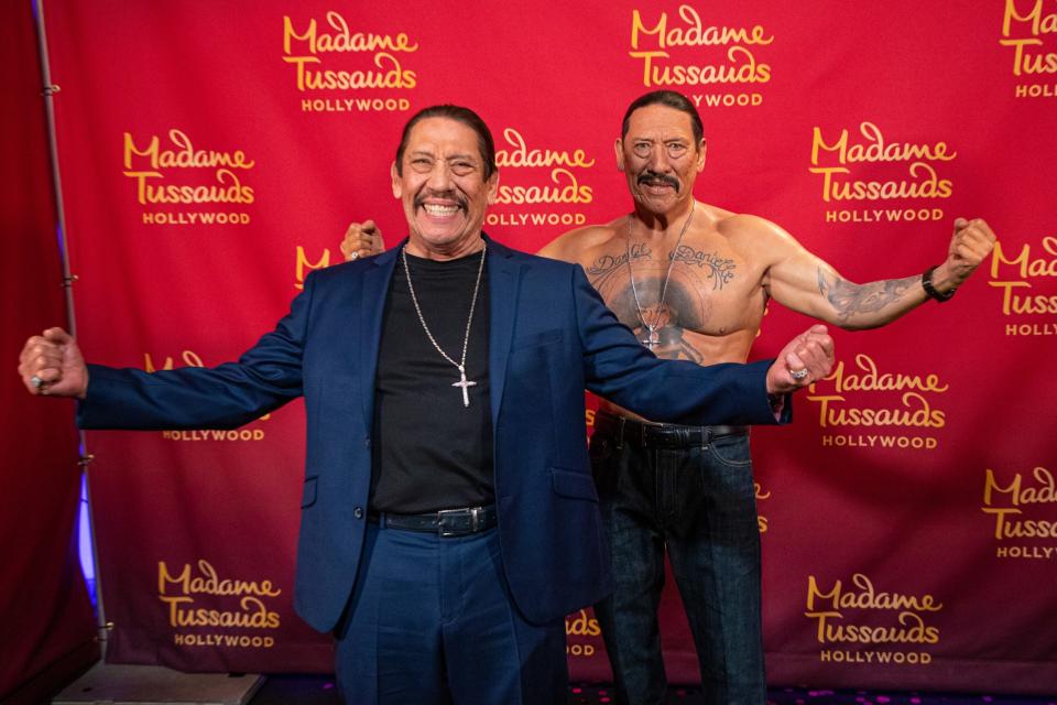 Danny Trejo (left) posing with his wax figure at Madame Tussauds Hollywood in October 2021.