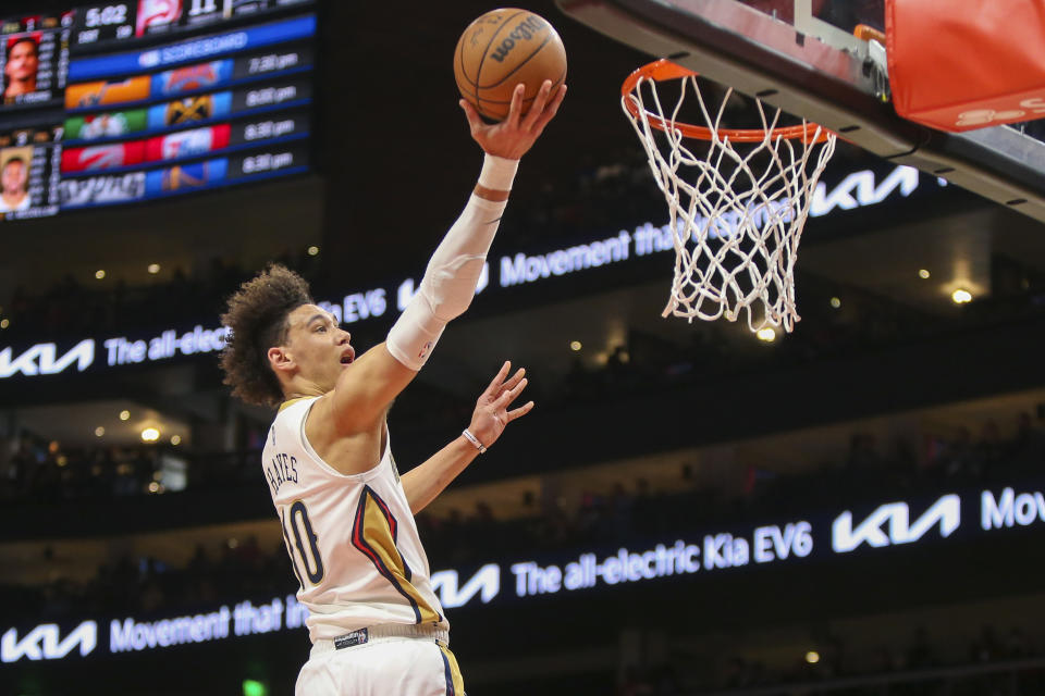 New Orleans Pelicans center Jaxson Hayes (10) shoots past Atlanta Hawks guard Bogdan Bogdanovic (13) in the first half of an NBA basketball game Sunday, March 20, 2022, in Atlanta, Ga. (AP Photo/Brett Davis)