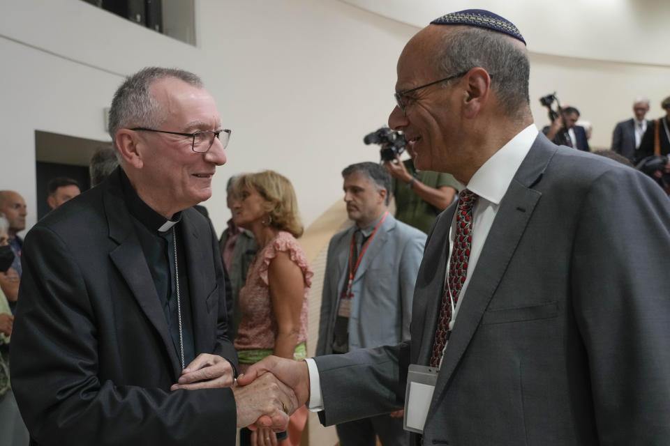 Vatican Secretary of State Pietro Parolin, left, shakes hands with Rabbi Noam Marans of the American Jewish Committee, during the international conference "New documents from the Pontificate of Pope Pius XII and their Meaning for Jewish-Christian Relations: A Dialogue Between Historians and Theologians", at the Gregorian University in Rome, Monday, Oct. 9, 2023. (AP Photo/Gregorio Borgia)