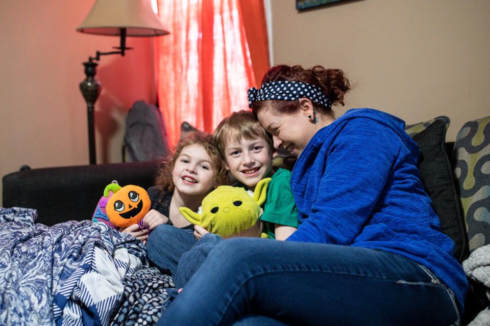 Shana Sharrar-Smith, who works at Ford's Michigan Assembly Plant in Wayne, spends time with her daughter Lilliana, 3, and son Seamus, 8, at her home in South Lyon before going to work at the factory Friday, April 1, 2022.