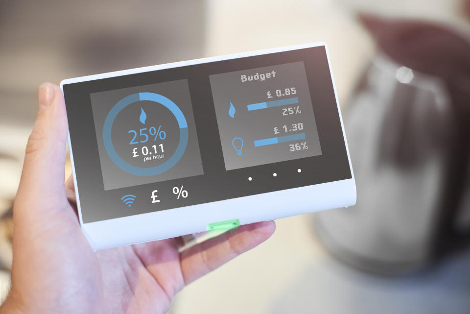 bills cost of living Smart meter on the wall of home interior showing current energy costsDesign on screen my own. Please see property release.