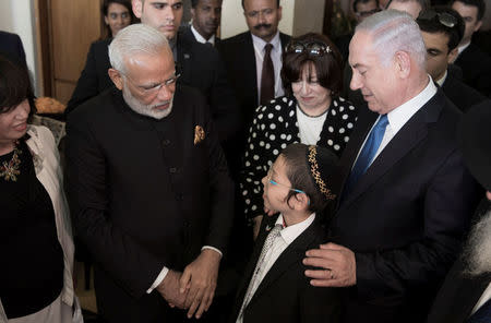 Indian Prime Minister Narendra Modi stands next to Israeli Prime Minister Benjamin Netanyahu, as they meet Moshe Holtzberg whose parents were killed during the November 2008 attacks in Mumbai at Nariman House, home to the Mumbai chapter of the Chabad-Lubavitch Jewish movement, in Jerusalem July 5, 2017. REUTERS/Atef Safadi/Pool