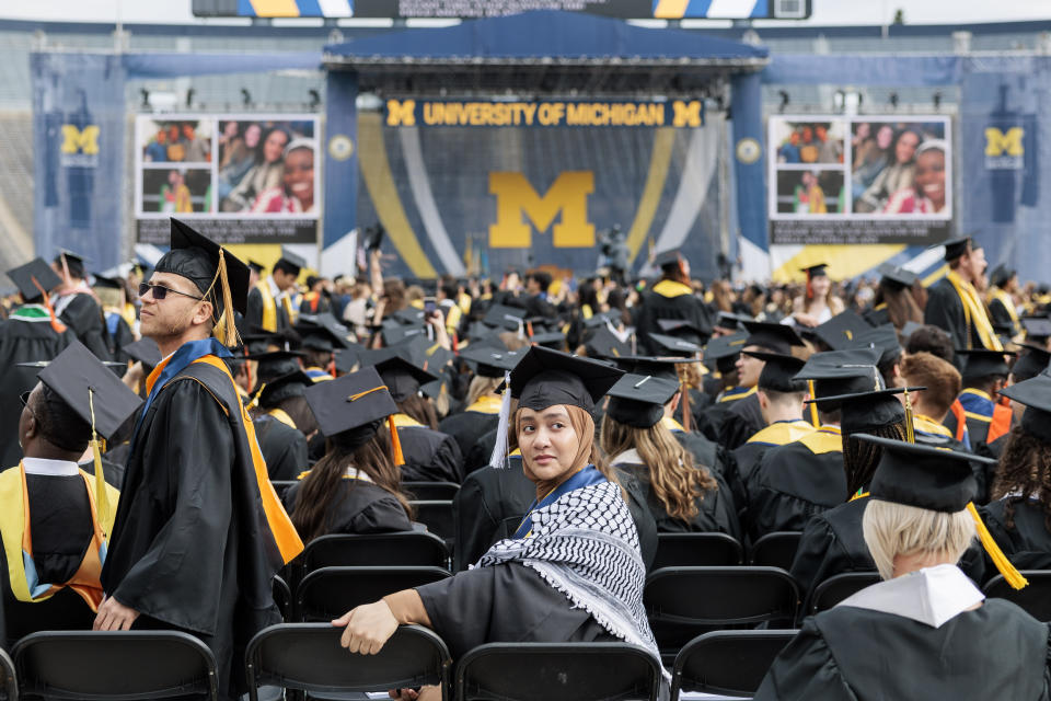 A graduate waits for the University of Michigan's Spring 2024 Commencement Ceremony to begin at Michigan Stadium in Ann Arbor on Saturday, May 4, 2024. (Jacob Hamilton/Ann Arbor News via AP)