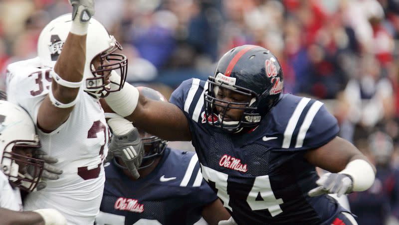 In this Nov. 28, 2008, file photo, Mississippi State defensive end Tim Bailey (39) is shoved back by Mississippi offensive lineman Michael Oher (74) in the first half of an NCAA college football game in Oxford, Miss.