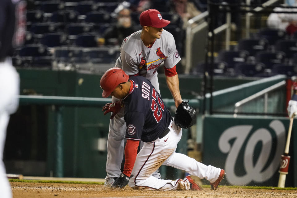 St Louis Cardinals starting pitcher Jack Flaherty (22) covers home as Washington Nationals' Juan Soto slides safely home after a passed ball during the fourth inning of a baseball game at Nationals Park, Monday, April 19, 2021, in Washington. (AP Photo/Alex Brandon)